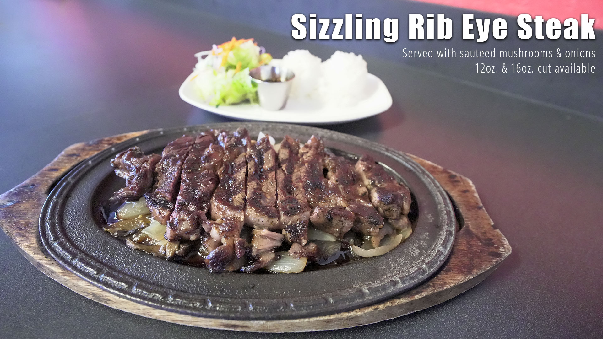 image of sizzling rib eye steak from Restaurant Kenichi